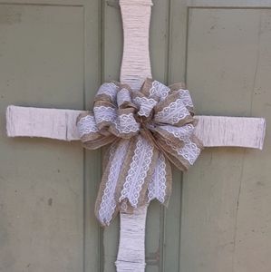 Wire cross covered with string, with burlap bow